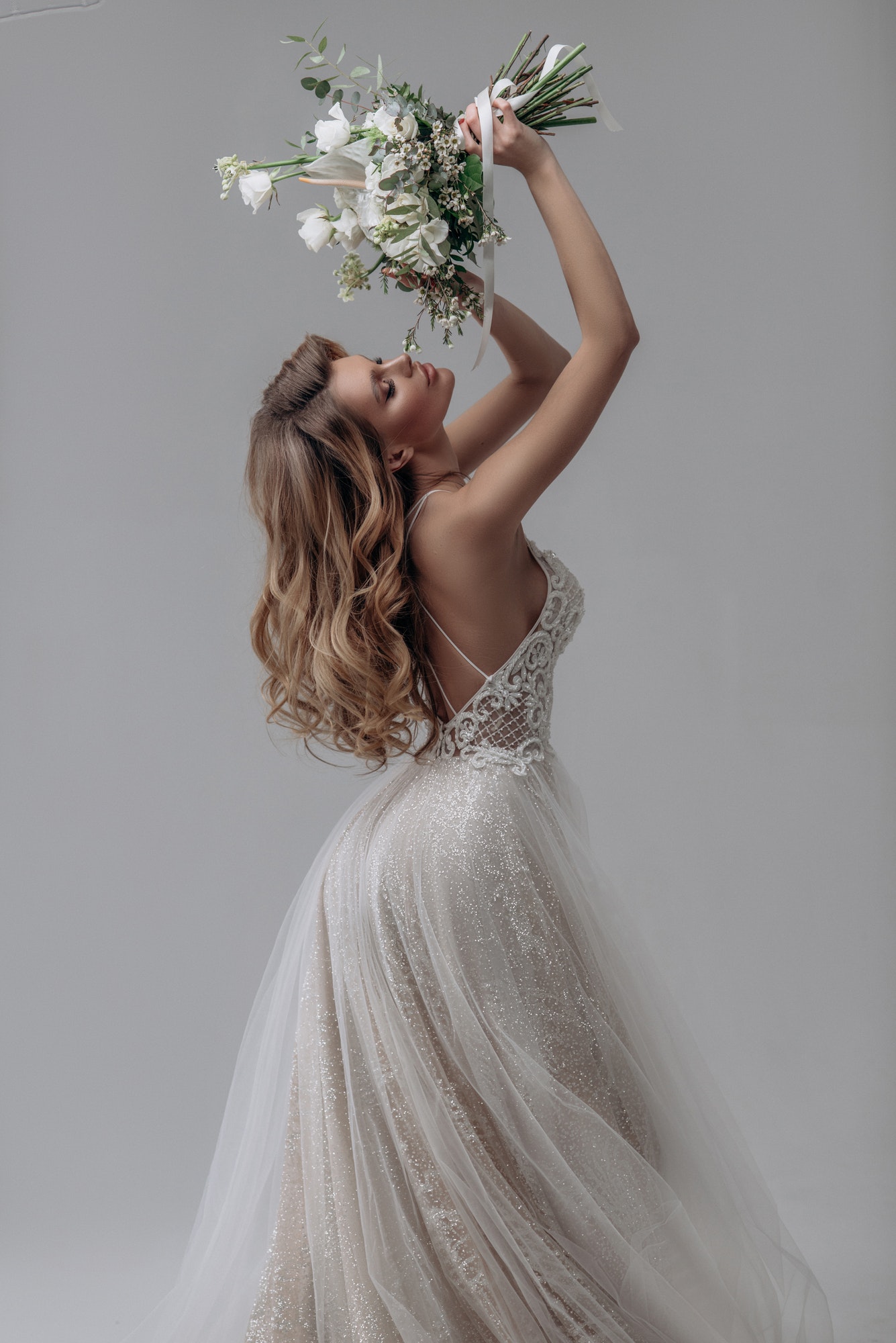 beautiful-sexy-blonde-bride-posing-in-wedding-dress-in-white-room.jpg